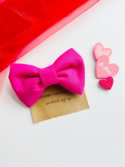 Bright pink bowtie for pets, attachable to most size collars